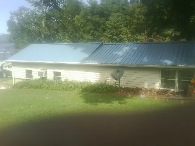 Blue metal roof running the length of a single story home in Bergton